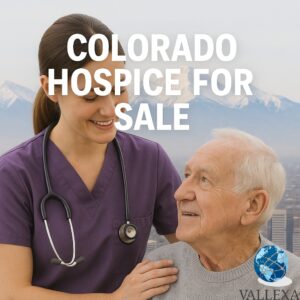 A hospice nurse in purple scrubs gently supports and smiles at an elderly male patient, with the Denver skyline and snow-covered Rocky Mountains in the background. Text overlay reads "Colorado Hospice For Sale."